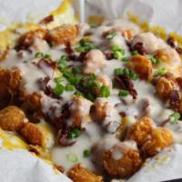 Smothered Hash Rounds  · Hash rounds loaded with cheese, bacon, gravy and green onions.