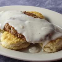 Biscuits And Gravy · Warm biscuits, smothered in gravy and topped with  sausage.