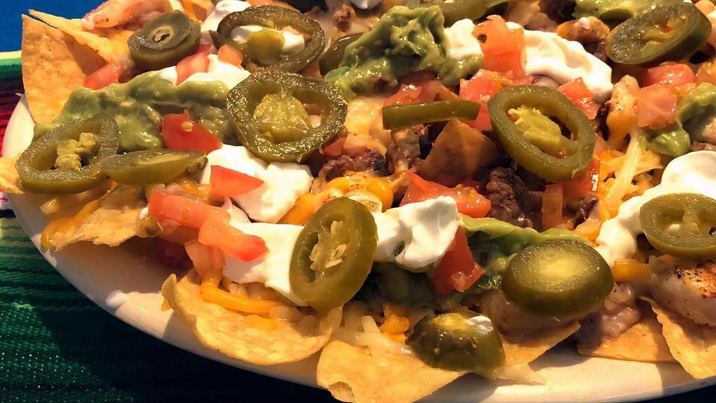Nachos · Tortilla chips topped with melted cheese and jalapeños.