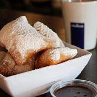 Alondra'S Beignets · Soft pillows of golden fried dough tossed in sweet powder sugar, served with rich chocolate ...