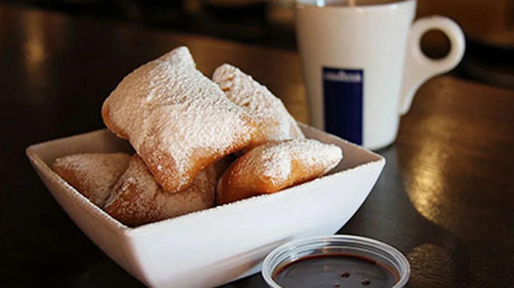 Alondra'S Beignets · Soft pillows of golden fried dough tossed in sweet powder sugar, served with rich chocolate and caramel sauce.