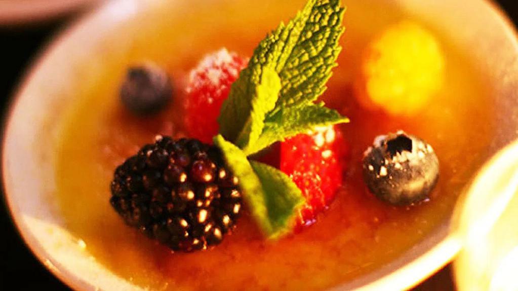 Vanilla Bean Créme Brulee · Topped with fresh berries.