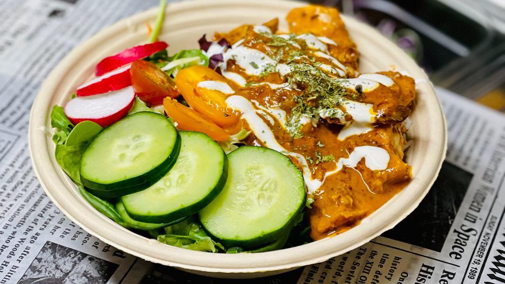 Chicken Makhni Curry Bowl (Butter Chicken) · Butter Chicken Curry (Chicken Makhni), Basmati Rice, Garden Salad w/ Vegetables & Pepper Masala Vinaigrette , Drizzled With Raita.