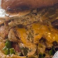 The 4X4 · Four Smashed Beef Patties, Four Slices of American Cheese, Hot Green Chile on a local made B...