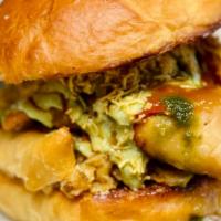 O.B. (Samosa On A Bun) · Two Samosas smashed in between a Local Baked Bun. Topped with Raita Sauce, Red Chile Garlic ...