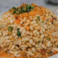 Bhel Puri · Savory chaat made of puffed rice, potatoes, tomatoes and onions topped with Sev, mint and ta...