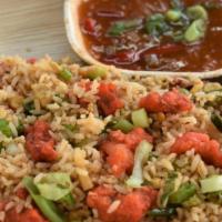 Chicken Fried Rice · Street style fried rice with chicken, eggs and vegetables. Served with hot and sweet sauce