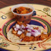 Tacos Of Cochinita Pibil · Marinated shredded pork, and pickle red onion on top.