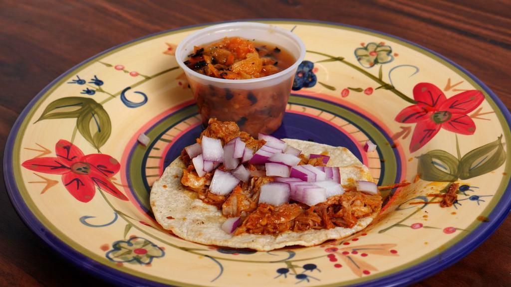 Tacos Of Cochinita Pibil · Marinated shredded pork, and pickle red onion on top.