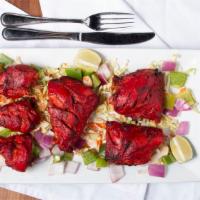 Tandoori Chicken · Grilled bone-in chicken marinated in yogurt, garlic, ginger and fresh ground spices.
