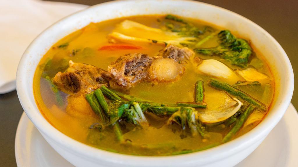 Sinigang · Tamarind base soup with bok choy, onions, long beans, tomatoes, and your choice of protein.