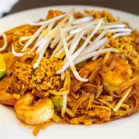 Pad Thai · Popular Thai noodle dish of stir fried rice noodles, egg, beansprouts, and peanuts, in a tan...