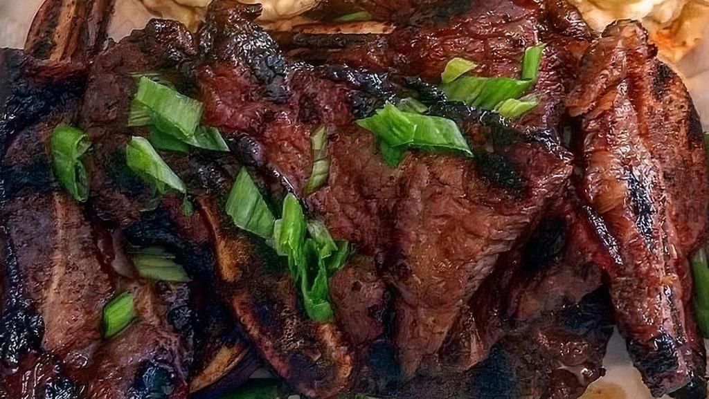 Kal-Bi Ribs · Grilled Thin Cut Beef Short Ribs in Korean Marinade. Served with Rice and Choice of Mac Salad or Green Salad with Sesame-Shoyu Dressing.