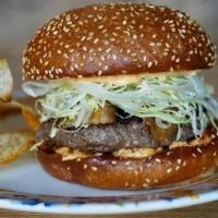 Cheeseburger · Topped with Tillamook Cheddar, Shredded Iceberg, Shaved Sweet Onion, Ketchup and Mayo on a G...