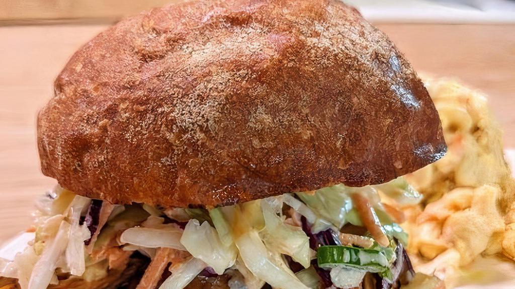 Shoyu Chicken Sandwich · Tender Shoyu Chicken Thigh with Creamy Cabbage & Pineapple Slaw and Spicy Mayo on Toasted Potato Bun. Served with Choice of Mac Salad or Green Salad with Creamy Sesame-Shoyu Dressing.