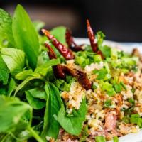 #17 Nam Khao Tod · Spicy pork crispy rice with lettuce, cilantro and peanut.