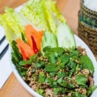 #8 Larb Gai (Chicken) · A savory minced chicken seasoned with lime, chilli powder, fish sauce, roasted rice powder a...