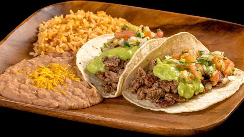 Two Carne Asada Tacos · Two carne asada tacos (steak) topped with guacamole and pico de gallo. Served with rice and beans.