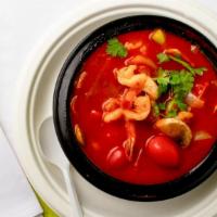Tom Yum Soup · Clear spicy soup with a touch of lemongrass, galangal root, kaffir leaves, tomatoes, onions,...