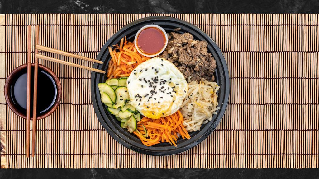 Bulgogi Boy Bibimbap · Fresh carrots, zucchini, bean sprouts, and radish with our famous beef bulgogi piled on fresh white rice, topped with a special spicy gochujang sauce and a fresh sunnyside-up egg. Yum!