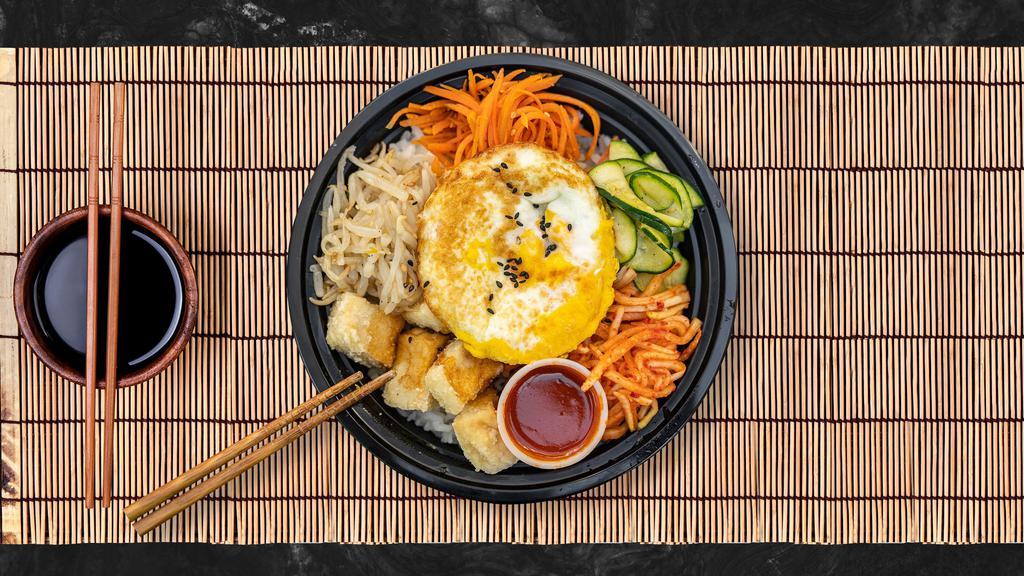 Tofu Crisp Bibimbap · Fresh carrots, zucchini, bean sprouts, and radish with our crispy fried tofu piled on fresh white rice, topped with a special spicy gochujang sauce and a fresh sunnyside-up egg.