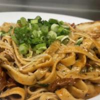 Blackened Chicken Linguine · Roasted garlic cream, sun-dried tomatoes, green onions topped with parmesan. Substitute shri...