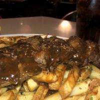 Bistro Steak · Bistro steak sirloin steak topped with port Demi and sautéed mushrooms served over garlic he...