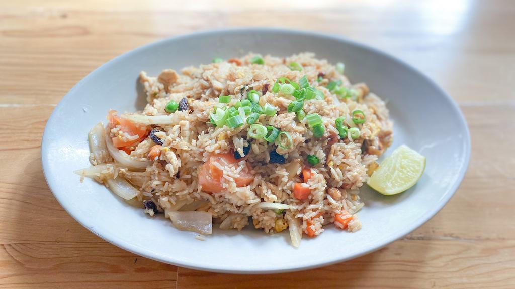 Pineapple Fried Rice · Fried rice with egg, onions, tomatoes, pineapples, cashew nuts, raisin and mixed pea-carrot.