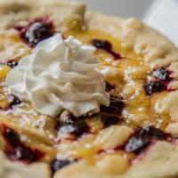 Dessert Pizza · Lightly baked pizza crust with cinnamon scented butter, fresh lemon curd, huckleberry puree,...
