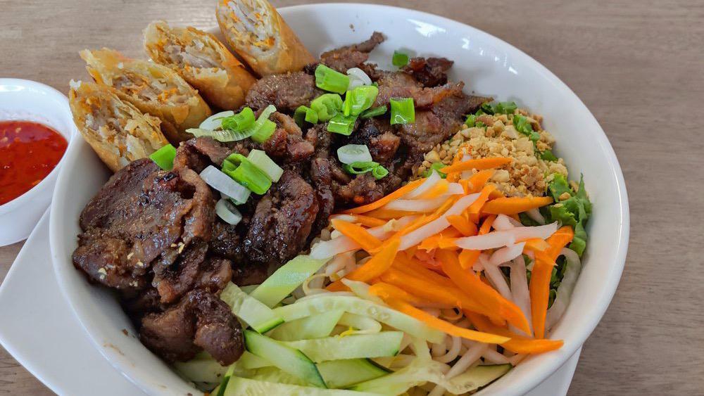 Grilled Pork & Deep Fried Egg Roll Vermicelli Bowl · Vermicelli noodle bowl with grilled pork, egg rolls, lettuce, bean sprout, Thai basil, picked carrot, daikon, peanut, and fried onions. Served with house fish sauce.