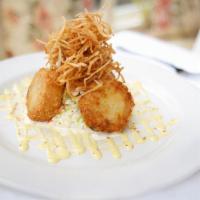 $15,000 Dungeness Crab Cakes · Green onions, celery, bacon, creole mustard sauce, coleslaw, and shoestring potatoes.