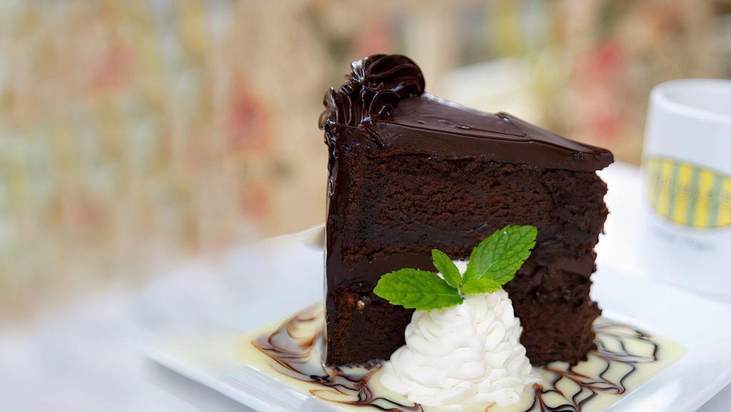 Devil’S Food Cake · Moist chocolate cake, rich chocolate ganache frosting, whipped cream,  and chocolate sauce