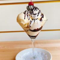 Hot Fudge Sundae · Housemade hot fudge with three scoops of vanilla bean ice cream, topped with whipped cream.