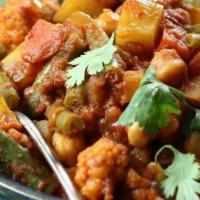 Vegetable Curry · Seasonal vegetable cooked with diced onions, whole peeled tomatoes, minced garlic, crushed g...