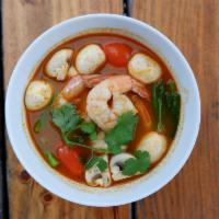 Tom Yum Soup · Hot and sour soup with lemongrass, galanga root, kaffir leaves, tomatoes, onion and mushroom.
