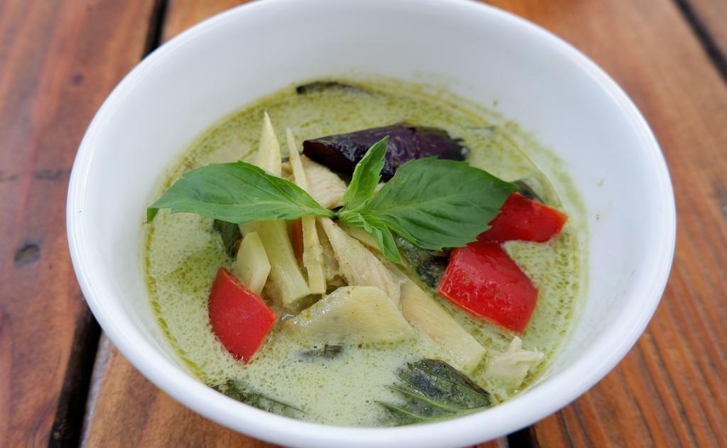 Green Curry · Green curry with coconut milk, eggplant, bamboo shoots, bell peppers and basil leaves served with rice.