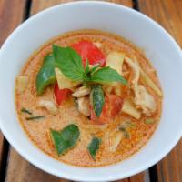 Red Curry · Red curry with coconut milk, bamboo shoots, bell pepper, and basil leaves served with rice.