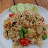 Pineapple Fried Rice · Fried rice with egg, raisins, onions, peas carrot, pineapple chunks, cashew nuts and tomatoes.