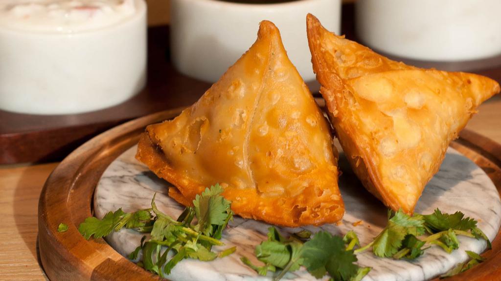 Samosa (2Ct) · Two crispy pastries stuffed with potatoes, peas, and secret spices. Served with house chutney.