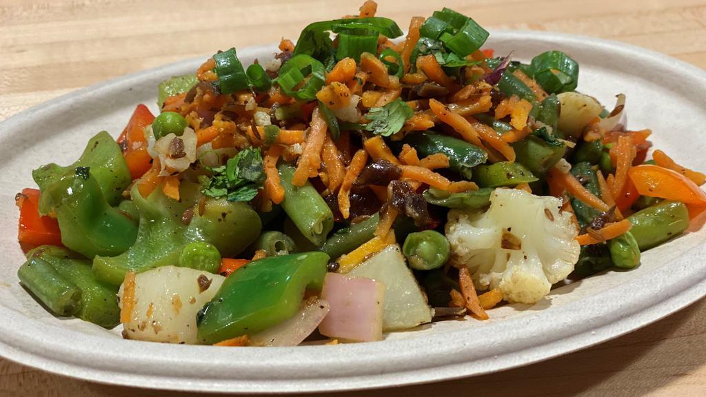 Tarka Vegetables · Cauliflower, potatoes, green beans, carrots and green peas sautéed with cumin, ginger & garlic.
