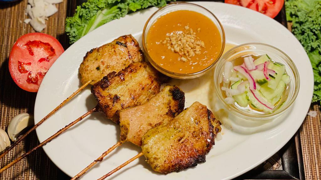 Chicken Satay · Tender marinated chicken breast, grilled on a skewer. Served with warm peanut sauce and a crisp cucumber salad.