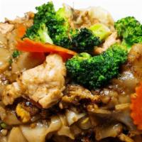 Pad See-Ew · Stir-fried wide rice noodles in dark soy sauce with meat, egg, broccolis, cabbages and carro...