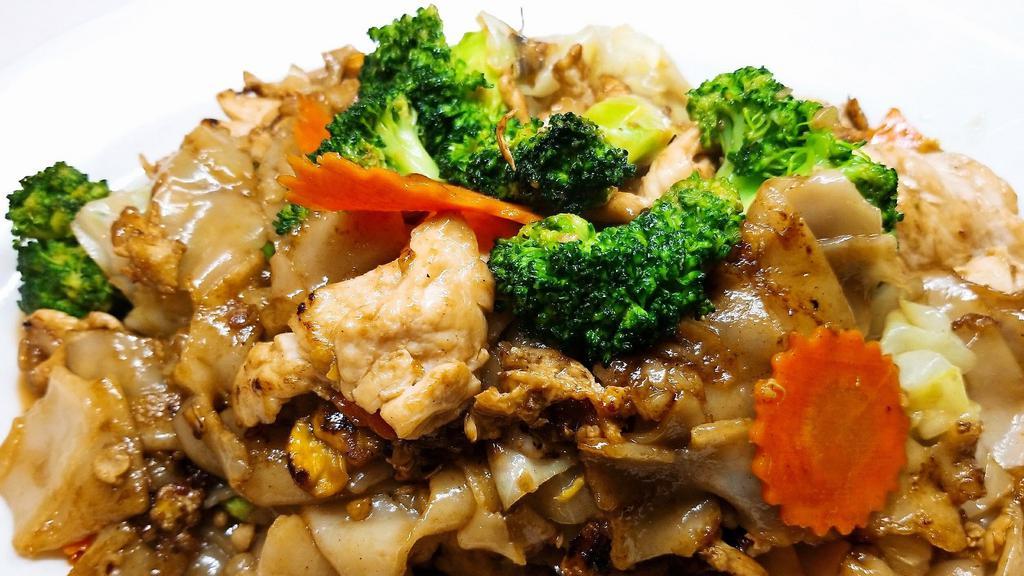Pad See-Ew · Stir-fried wide rice noodles in dark soy sauce with meat, egg, broccolis, cabbages and carrots.