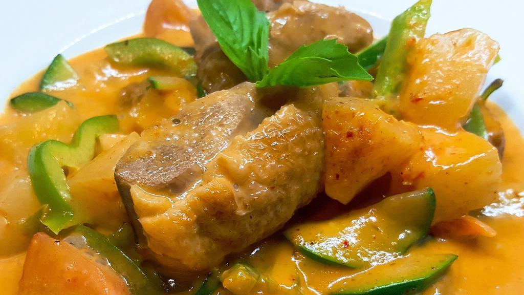 Roast Duck Curry · An exotic flavored Tender duck meat in red curry, with bell pepper tomato, zucchini, pineapple and sweet basil.