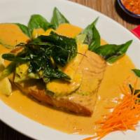 Choo Chee Salmon · Grilled King Salmon filet glazed with a panang curry cream sauce and topped with crispy basil.