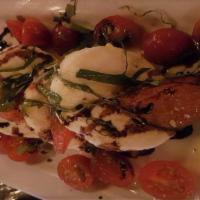 Heirloom Caprese Salad · Fresh house-made Mozzarella cheese, heirloom tomatoes and fresh basil chiffonade drizzled wi...