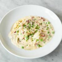 Spaghetti Carbonara · Tossed with pancetta, onions, and Parmigiana Reggiano then finished with a poached egg.