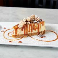 Amaretto Cheesecake · A creamy cheesecake with an almond biscotti crust, served with caramel sauce and candied alm...