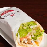 Chicken Shawarma Sandwich · Marinated grilled chicken wrapped with tomatoes, cucumbers lettuce, hummus,  and garlic sauce.