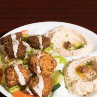 Mixed Veggie Plate · Falafels and cauliflower over greek salad, topped with tahini sauce. Served with hummus, bab...